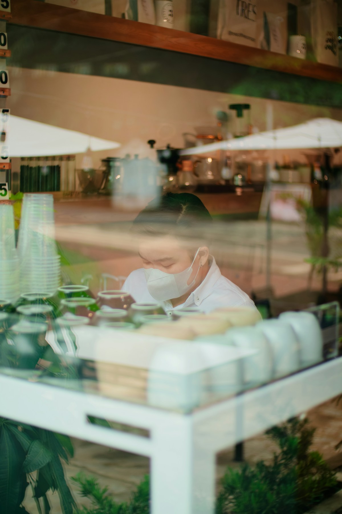A man sitting at a table in front of a window in the Philippines