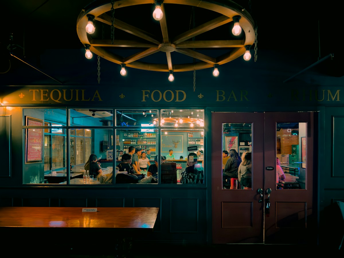A group of people sitting at a table in front of a restaurant in the Philippines