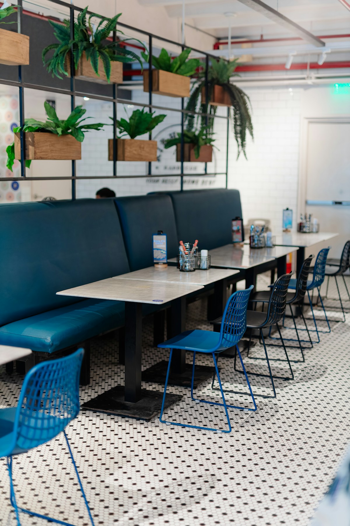 A stylish restaurant interior features greenery and seating in the Philippines