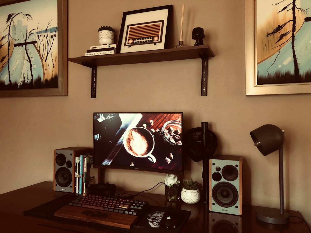 Black flat screen computer monitor turned on beside black computer keyboard in the Philippines